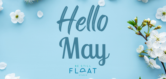 Text that says "Hello May" placed over a light blue background with white flowers around the border.